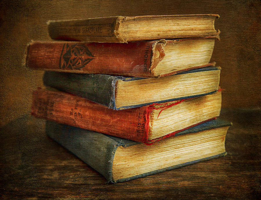 Stack of five worn antique books with frayed cloth covers